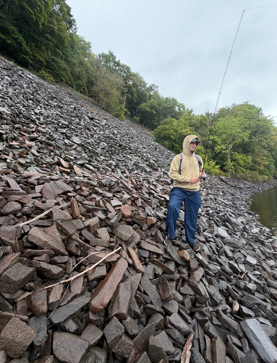 Jimmy Stratton fishing a rocky bank with his rod
